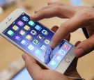 A shopper tries out the new Apple iPhone 6 at the Apple Store on the first day of sales of the new phone in Germany on September 19, 2014 in Berlin, Germany.