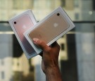  One of the first customers to buy a new iPhone walks out of an Apple store in Manhattan on September 16, 2016 in New York City.