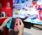 A guest enjoys playing Mario Kart 8 Deluxe on the groundbreaking new Nintendo Switch at a special preview event in New York on Jan. 13, 2017.