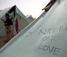 A Nigerian woman eats an orange outside her tent at a United Nations displacement camp on March 16, 2011 in Ras Jdir, Tunisia. 