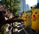 Performers dressed as Pikachu, a character from Pokemon series game titles, march during the Pikachu Outbreak event hosted by The Pokemon Co. on August 7, 2016 in Yokohama, Japan.