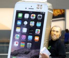 A customer wearing a Steve Jobs mask celebrates after purchasing a new iPhone at the launch of the new Apple iPhone 6 and iphone 6 plus at the Apple Omotesando store on September 19, 2014 in Tokyo.