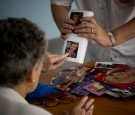 Social worker Nuria Casulleres shows a portrait of Prince Charles, Prince of Wales to an elderly woman during a memory activity at the Cuidem La Memoria elderly home.