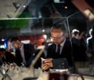 A visitor checks HTC mobile phones at the Mobile World Congress in Barcelona, Spain. 