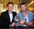 Actors Tom Hiddleston and Chris Hemsworth sign autographs during Comic-Con 2010 on July 24, 2010 in San Diego, California. 