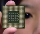 A woman displays the latest US-made Intel PC processor during a press conference at a local department store in Taipei, 28 August 2001.