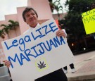  Florida Attorney General candidate Jim Lewis, who is running on a platform of legalizing marijuana, holds a sign during a campaign rally on October 12, 2010 in Fort Lauderdale, Florida. 