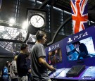 Gamers play the video game 'Assassin's Creed Syndicate' developed by Ubisoft on PlayStation games consoles PS4 at Paris Games Week, a trade fair for video games on October 29, 2015 in Paris, France.