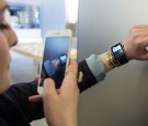 A French customer uses an iPhone 6 smartphone to take a photo of an Apple Watch, during the device presentation at an Apple store in Lyon, central-eastern France, on April 10, 2015. 