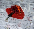 SEPTEMBER 01: Messages are left on a white banner for slain WDBJ photojournalists Adam Ward and Alison Parker at a make shift memorial outside the station September 1, 2015 in Roanoke, Virginia.