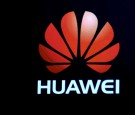 A Huawei logo is shown on a screen during a keynote address by CEO of Huawei Consumer Business Group Richard Yu at CES 2017.