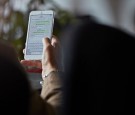 Close-up of man texting with girl friend on phone