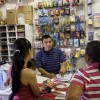 A Hispanic owner entertaining his customers