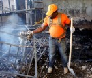 Worker Pouring Water at the Orphanage