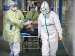 Medical workers in protective suits move a patient inside an isolated ward of a hospital in Wuhan, Hubei province, China, February 6.