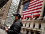 A man wears a mask to prevent exposure to the coronavirus disease (COVID-19) while walking past the New York Stock Exchange