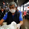 An elderly man, working as a packer at a supermarket, wears a protective face mask as a security measure for the coronavirus disease (COVID-19), in Mexico City
