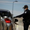 U.S. Customs and Border Protection police officer talks to a driver as the coronavirus disease (COVID-19) outbreak continues at Paso del Norte International Border bridge as taken from Ciudad Juarez,