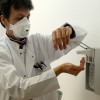 Chief doctor Katja de With wears protection gear and washes her hands during a media event in the newly opened coronavirus disease (COVID-19) clearing-up centre in Dresden