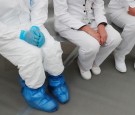 A medical specialist wearing protective gear sitting next to two nurses inside the new immediate response mobile hospital in Pachuca