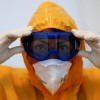 A medical staff of a general practitioner adjusts her googles before she walks to a coronavirus disease (COVID-19) test center set up outside a doctor's office in Berlin