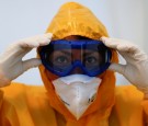 A medical staff of a general practitioner adjusts her googles before she walks to a coronavirus disease (COVID-19) test center set up outside a doctor's office in Berlin