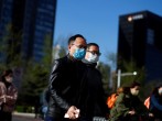 People wear masks as they head to work during morning rush hour, amid the outbreak of coronavirus disease (COVID-19), in the central business district in Beijing, China