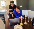 Cheryl Noah and Alex Barkin use a computer during a family Passover Seder to connect with relatives who are unable to gather together due to the outbreak of Coronavirus disease (COVID-19) in Maplewood, New Jersey, U.S