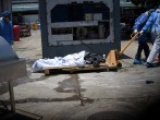 Health workers wearing protective gear bring a dead body past a refrigerated container outside of Teodoro Maldonado Carbo Hospital amid the spread of the coronavirus disease (COVID-19), in Guayaquil