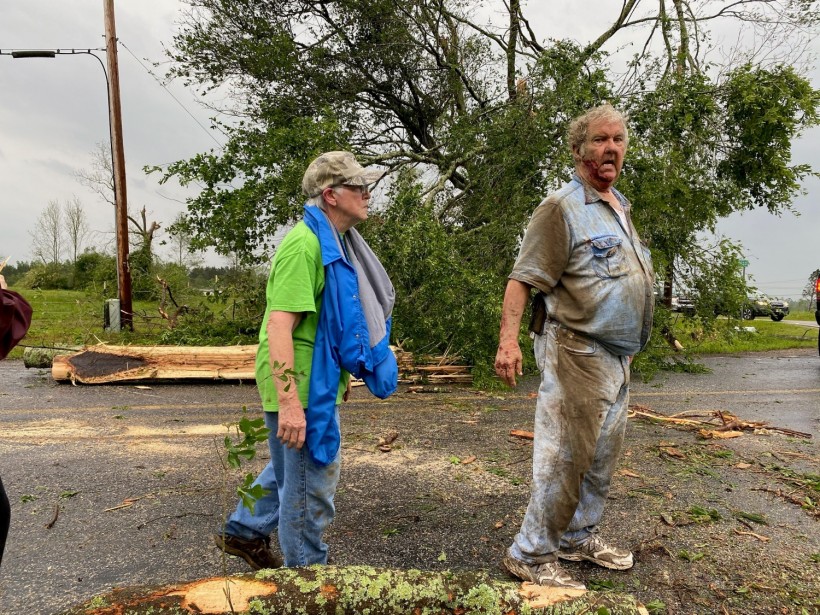 Jo and James Neely view the destruction of a tornado that hit the area on Easter Sunday afternoon in Soso, Mississippi, U.S. April 12, 2020. 