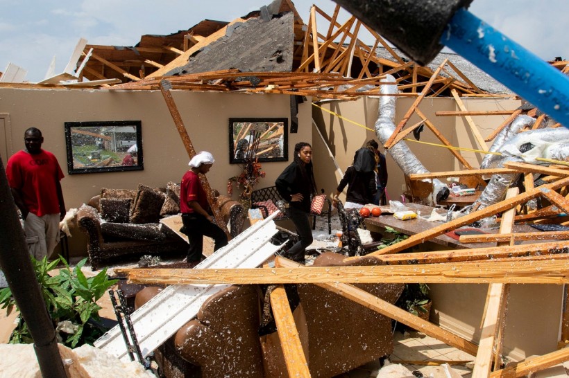 Residents comb through the wreckage of a collapsed house after an Easter Sunday tornado ripped through the Cherry Blossom Drive neighborhood in Monroe, Louisiana, U.S. April 12, 2020