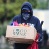 A man carries away fresh food at a Los Angeles Regional Food Bank giveaway 