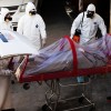 Funeral workers remove the body of a coronavirus disease (COVID-19) victim from a hearse at a funeral parlor, in Ciudad Juarez, Mexico