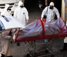 Funeral workers remove the body of a coronavirus disease (COVID-19) victim from a hearse at a funeral parlor, in Ciudad Juarez, Mexico