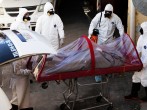 Funeral workers remove the body of a coronavirus disease (COVID-19) victim from a hearse at a funeral parlor, in Ciudad Juarez, Mexico