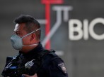 A police officer wearing a protective mask stands at the entrance of a coronavirus testing site, as the coronavirus disease (COVID 19) continues in Mexico City