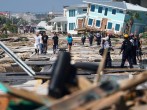 First responders and residents walk along a main street following Hurricane Michael in Mexico Beach, Florida, U.S.