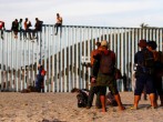 Migrants, part of a caravan of thousands trying to reach the U.S., gather at the border fence between Mexico and the United States after arriving in Tijuana, Mexico November 13, 2018.