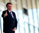 Brazil's President Jair Bolsonaro gestures as he stands at the ramp of the Planalto Palace, in Brasilia