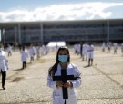 Nurses wearing protective face masks hold crosses during a symbolic protest and tribute for health workers on Labour Day, in Brasilia