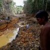  A Yanomami indian follows agents of Brazil's environmental agency in a gold mine during an operation against illegal gold mining on indigenous land, in the heart of the Amazon rainforest, in Roraima state, 