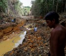  A Yanomami indian follows agents of Brazil's environmental agency in a gold mine during an operation against illegal gold mining on indigenous land, in the heart of the Amazon rainforest, in Roraima state, 