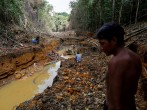  A Yanomami indian follows agents of Brazil's environmental agency in a gold mine during an operation against illegal gold mining on indigenous land, in the heart of the Amazon rainforest, in Roraima state, 