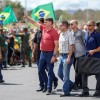 Brazil's President Jair Bolsonaro gestures after joining his supporters, who were taking part in a motorcade to protest against quarantine and social distancing measures, amid the COVID-19 outbreak, in Brasilia, Brazil.