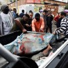 Residents carry dead bodies after a police operation against drug gangs in Rio de Janeiro