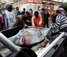 Residents carry dead bodies after a police operation against drug gangs in Rio de Janeiro