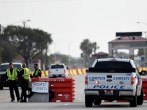 Police officers stand at a checkpoint after a shooting incident at Naval Air Station Corpus Christi