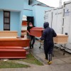 Workers carry a coffin outside of the crematorium at Angel Cemetery, where victims of COVID-19 are cremated in Lima, Peru.