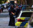 Police officers wearing protective equipment gather at the scene of a shooting incident in Darmstadt