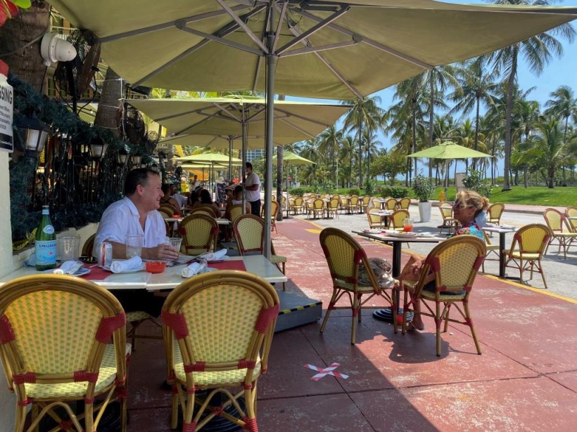 People sit at Il Giardino restaurant as restaurants reopen with restrictions to limit the spread of the COVID-19 on Ocean Drive on South Beach in Miami, Florida, US.